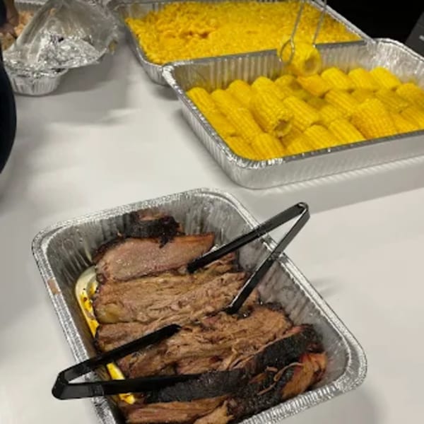 Baby Back Blues BBQ brisket, mac and cheese, and corn on the cob in foil pans.